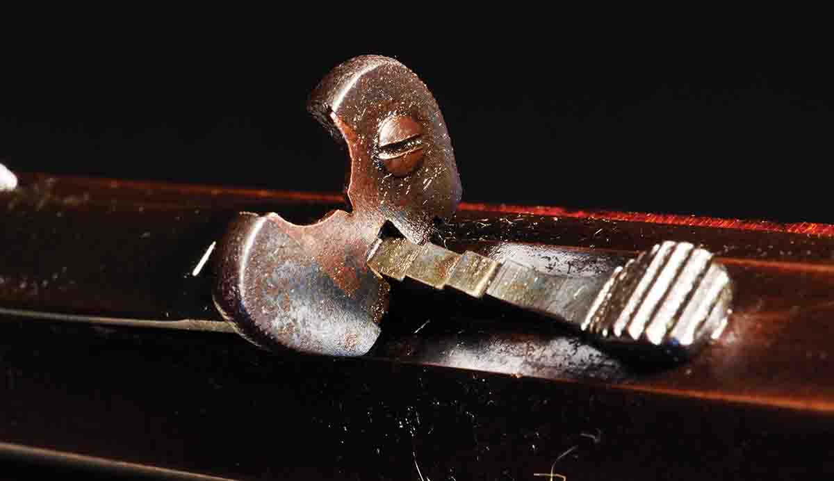 This variation on the “semi-buckhorn” is on a Winchester Low Wall from the 1890s. The notch can be moved up and down inside the aperture, and the sight as a whole can be raised or lowered by means of the usual stepped slide. The front bead can be positioned between the upper ears of the blade or low in the notch.